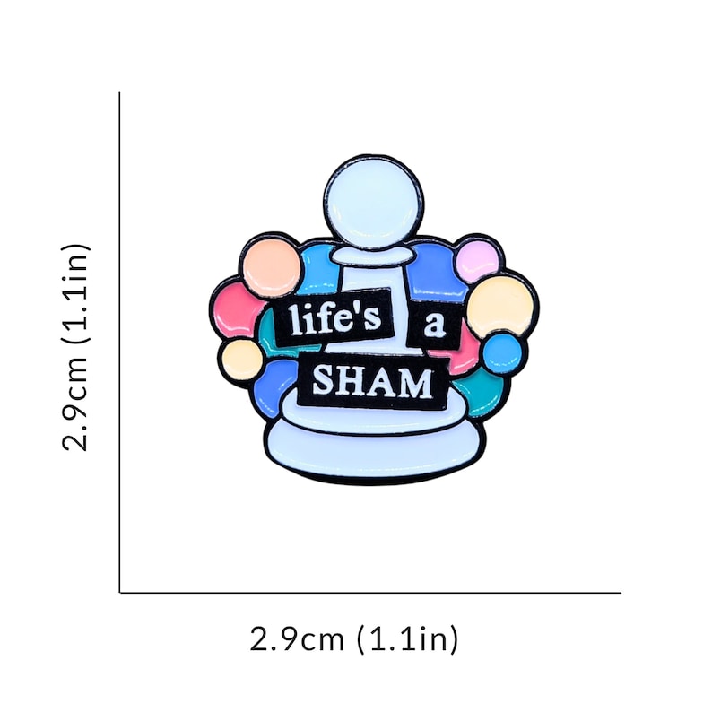 May include: A white chess pawn with a colorful circle design around it. The pawn has the words "life's a sham" written on it.
