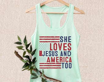 May include: A light green tank top with a distressed American flag design and the text "She Loves Jesus and America Too".
