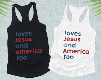 May include: Two tank tops, one black and one white, with the text "loves Jesus and America too" in blue and red. The shirts have a racerback design and are made of a soft material.
