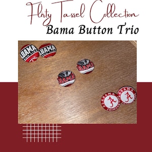 May include: Six round fabric-covered buttons featuring University of Alabama themes, including text reading BAMA SON TIDE, BAMA with an elephant mascot, and ALABAMA CRIMSON TIDE with a script A logo. The text Flirty Tassel Collection Bama Button Trio is visible.