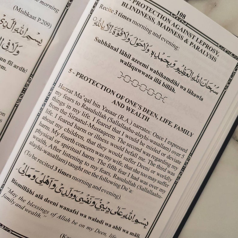 May include: A page from a book with Arabic text and a section titled "Protection of One's Deen, Life, Family and Wealth". The text discusses the importance of seeking protection from harm and illness. The page is yellowed with age and has a worn, vintage look.