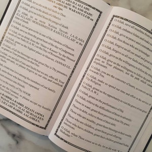 May include: An open book with a white background and black text. The text is in Arabic and English. The English text reads "O Allah, give us the death of a Martyr. O Allah, let us die with full faith in Thee. O Allah, give us relief from the pangs of death. O Allah, let us recite 'Kalima Tayyab: LA-ILAHA ILLALLAHU MOHAMMEDUR RASUULULLAH' at the time of death. O Allah, let our graves be in one of the Gardens of Heaven. O Allah, save us from the great heat of the day of judgement. O Allah, let us drink from the 'Haus-e-Kauser' by the blessed hands of our Nabi (S.A.W.) on the Day of Resurrection. O Allah, grant us the highest place in Heaven, JANNAT-UL-FIRDAUS. O Allah, of all the blessings on that great Day is Thy presence, so grant us Your presence on that Day. O Allah, we are full of sins and faults but we are, after all, Your humble servants, so please forgive us our sins and overlook faults. O Allah, create true love among the members of our family. O Allah, unite those who have been separated. O Allah, turn enemies into friends. O Allah, give us the reality of Thy NOOR. You are the Greatest, so please accept my humble sinful servant. RABBIKA RABBIL IZZATI AMMA WASALAMUN ALAL MURSALEEN LILLAHI RABBIL AALAMEEN."