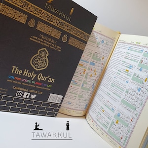 May include: A black and gold Quran with colour-coded Tajweed rules. The cover features Arabic calligraphy and the title "The Holy Quran". The book is open to a page with Arabic text and English translation.