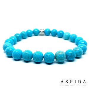 May include: Turquoise gemstone bracelet with silver beads. The bracelet is made of round, smooth stones with a light blue colour and a marbled pattern.