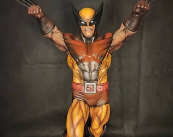 May include: A detailed action figure of Wolverine, a Marvel Comics superhero, in a yellow and brown costume with red accents. He is posed with his claws extended and a fierce expression on his face.