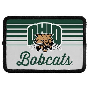 May include: A rectangular embroidered patch featuring the Ohio Bobcats logo. The design includes a green and white striped background, the word OHIO in bold green letters, a bobcat mascot head, and the word Bobcats in green script text.