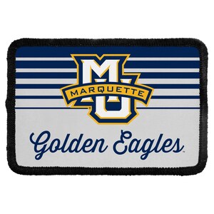 May include: A rectangular patch with a black stitched border featuring the Marquette University logo in blue, gold, and white. The design includes horizontal blue and white stripes, the text Marquette, and the script text Golden Eagles in dark blue.