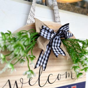 a welcome sign hanging on a wall