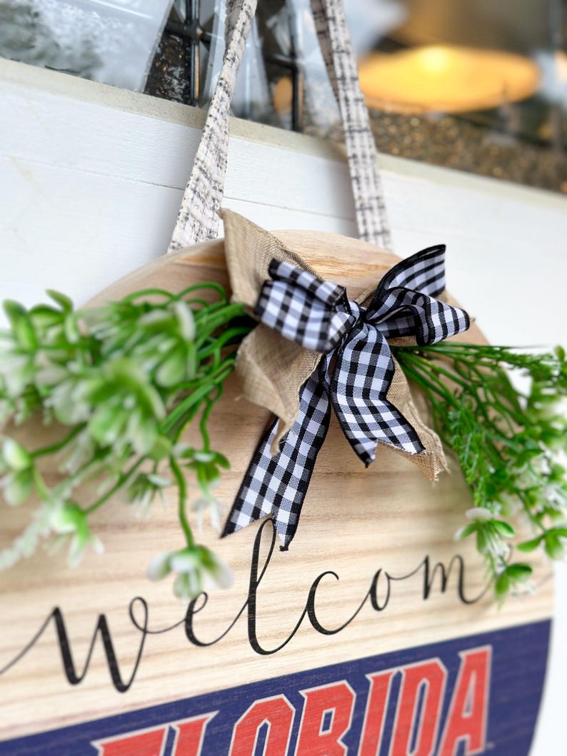 a welcome sign hanging on a wall