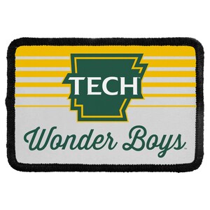 May include: A rectangular embroidered patch with a black stitched border. The design features a yellow and white striped background, a green outline of the state of Arkansas containing the white text TECH, and the green script text Wonder Boys.