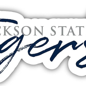 May include: A white sticker with the words "Jackson State Tigers" in navy blue script and gray block letters. A floral design in navy blue is on the right side of the sticker.