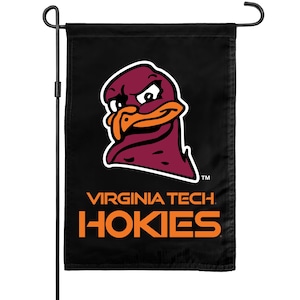 May include: A black garden flag featuring the maroon and orange Virginia Tech Hokies turkey mascot logo at the top, with the text VIRGINIA TECH HOKIES printed in orange below the mascot. The flag is displayed on a black metal garden flag stand.