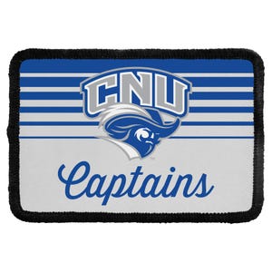 May include: A rectangular patch with a black stitched border featuring a blue and white striped background. The center displays a grey and blue CNU logo above a blue mascot head icon and the blue cursive text Captains with a small trademark symbol.