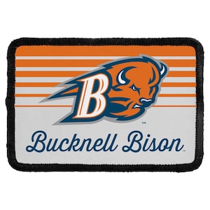 May include: A rectangular patch with a black stitched border featuring an orange and white striped background. It displays a stylized orange bison head logo with a large white letter B and the text Bucknell Bison in dark blue script.