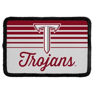 May include: A rectangular patch with a black stitched border. The top half features horizontal maroon and white stripes with a large, centered silver and maroon letter T. The bottom half is white with the word Trojans written in maroon script.