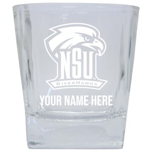 May include: A clear glass shot glass with a white NSU Riverhawks logo and the text "YOUR NAME HERE" etched on the front.