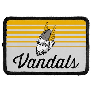 May include: A rectangular patch with a black stitched border. The background features horizontal yellow and white stripes. A graphic of a cartoon Viking head with a winged helmet is centered above the black cursive text reading Vandals.