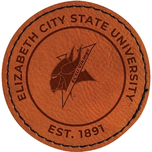 May include: A round, brown leather coaster with the text "ELIZABETH CITY STATE UNIVERSITY" in a circular pattern. The center features a Viking logo and the words "ECSU Vikings." The bottom reads "EST. 1891."