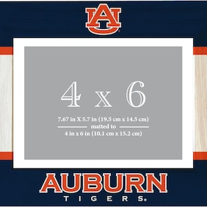 May include: A blue and white picture frame with a wood-look border. The frame has the Auburn University logo and the text "AUBURN TIGERS." The frame is designed to hold a 4x6 inch photo, which can be matted to a 7.67x5.7 inch size.