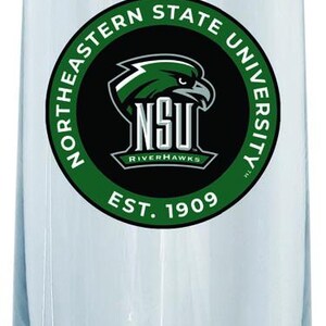 May include: A clear glass champagne flute with a green and black logo that reads "Northeastern State University" and "NSU Riverhawks" with the text "Est. 1909" underneath.