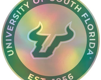 May include: A green and gold iridescent sticker with the University of South Florida logo. The logo features a green bull's head with a white outline. The text "University of South Florida" is written in a circle around the bull's head. The text "Est. 1956" is written below the bull's head.