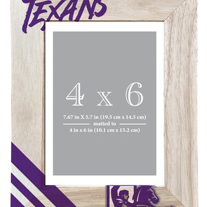 May include: A wooden picture frame with the word "TEXANS" in purple. The frame is designed for a 4 x 6 inch photo, matted to 4 x 6 inches. The frame measures 7.67 x 5.7 inches (19.5 cm x 14.5 cm).