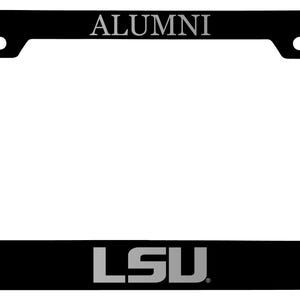 May include: Black license plate frame with the word "ALUMNI" at the top and "LSU" at the bottom in silver lettering. The frame has a rectangular shape with rounded corners and a white center.