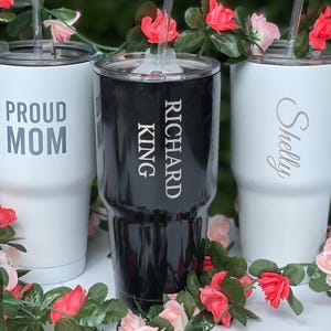 three personalized tumblers sitting on top of a table