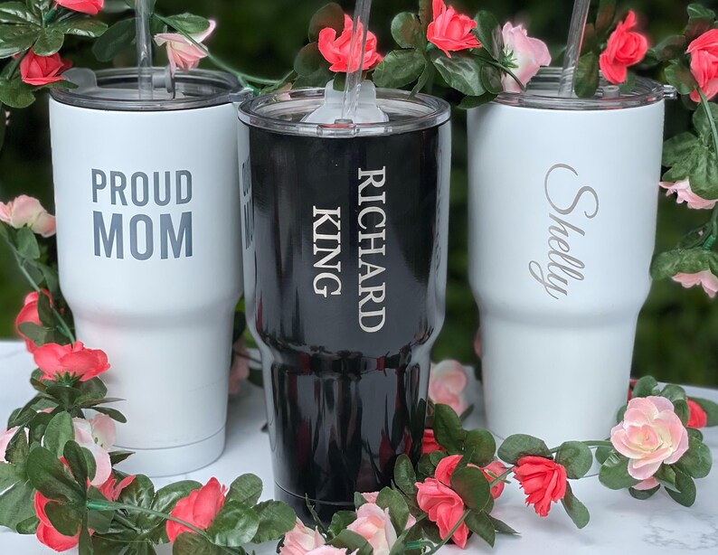 three personalized tumblers sitting on top of a table