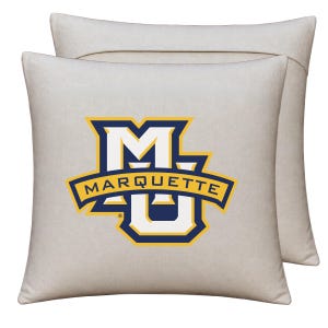 May include: A square, light beige throw pillow featuring the Marquette University logo in the center. The logo consists of a large white letter M with a blue and yellow outline, overlaid with a yellow banner containing the word MARQUETTE.