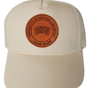 May include: A white ceramic mug with a black handle and the text "But First, Coffee" in a black, bold font. The mug is on a white surface. The mug is approximately 4 inches tall.