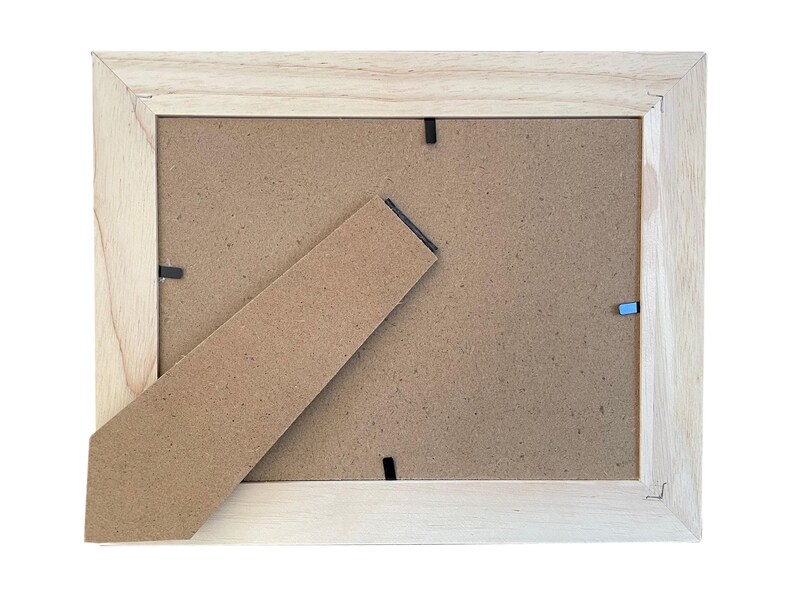 a picture frame with a piece of cardboard sticking out of it