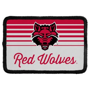 May include: A rectangular patch with a black stitched border. The design features horizontal red and white stripes on the top half, a central graphic of a red and black wolf head, and the text Red Wolves in red script on the white bottom half.