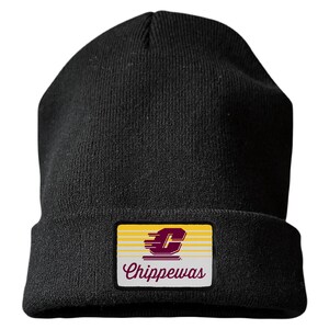 May include: A black knit beanie featuring a rectangular patch on the front cuff. The patch displays a yellow background with horizontal white lines, a maroon letter C with motion lines, and the word Chippewas written in maroon script lettering.