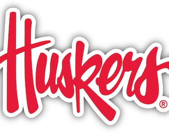 Peut inclure: Logo stylisé en rouge et blanc pour les "Huskers" avec un symbole de marque déposée.