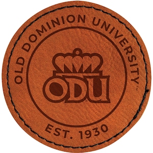 May include: A round, brown leather patch with the words "OLD DOMINION UNIVERSITY" in a circular pattern. The center features a crown above the letters "ODU" and the text "EST. 1930". The edge is stitched with black thread.