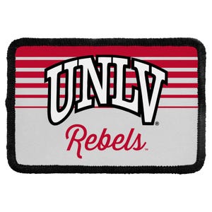 May include: A rectangular patch with a black stitched border. The top half features horizontal red and white stripes. The text UNLV is printed in large white letters with black outlines, and the word Rebels is written below in red script.