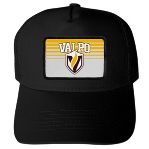 May include: A black trucker hat featuring a rectangular patch on the front. The patch displays the text VALPO in white letters above a shield emblem containing a yellow flame graphic. The background of the patch has horizontal yellow and white stripes.