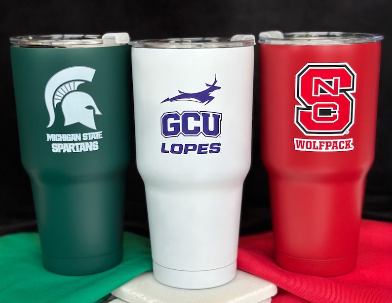 three different colored tumblers sitting next to each other