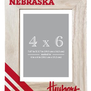 May include: Wooden photo frame with the text "NEBRASKA" at the top and "Huskers" at the bottom. The frame is designed for a 4 x 6 inch photo, matted to 4 x 6 inches. The frame's dimensions are 7.67 x 5.7 inches (19.5 cm x 14.5 cm).