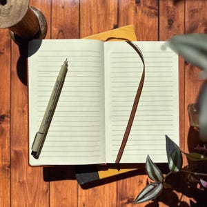 an open notebook with a pen on top of it