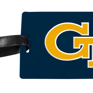 May include: A blue luggage tag with a gold Georgia Tech logo. The logo is a stylized "GT" with a white outline. The tag has a black strap.