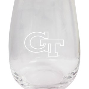 May include: A clear glass stemless wine glass with a white Georgia Tech logo etched on the front.
