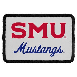 May include: A rectangular patch with a white background and a black stitched border. The text SMU is printed in large red block letters, and the word Mustangs is printed below in a blue cursive script font, both centered on the patch.