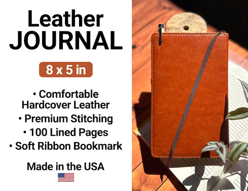 a brown leather journal sitting on top of a wooden table