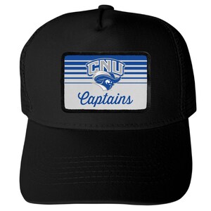 May include: A black trucker hat featuring a rectangular patch on the front. The patch displays blue and white horizontal stripes, the text CNU, a mascot logo, and the word Captains in a blue script font against a white background.