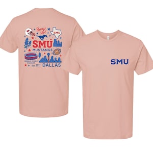 May include: A light pink short-sleeve t-shirt featuring a small blue SMU logo on the front chest. The back displays a graphic with the text Pony Up, SMU Mustangs, Gerald Z. Ford Stadium, Est. 1911, and Dallas, alongside icons of a helmet, horse, and football.