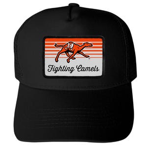 May include: A black trucker hat featuring a rectangular patch on the front. The patch displays an orange graphic of a running camel with a white saddle marked with a C, set against orange and white horizontal stripes, with the text Fighting Camels.