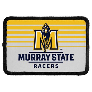 May include: A rectangular embroidered patch with a black border featuring a yellow and white horizontal striped background. It displays a large letter M with a horse and jockey graphic, followed by the text MURRAY STATE RACERS in navy blue.