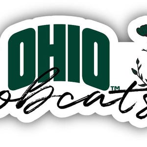 May include: A white sticker with the words "OHIO Bobcats" in a combination of dark green and black script. The word "OHIO" is in a block font. A floral design is on the right side.